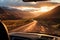 Breathtaking Mountain Landscape. Sunlit Road and Majestic Peaks Captured Through Car Window