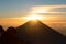 Breathtaking Mountain Top View of Sun Shining through Volcano Peak