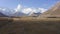 A breathtaking panorama of snow-capped mountains, colorful rocks and green hills of the Pamirs.