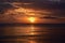 Breathtaking scene of the sunset in the cloudy sky over the ocean - perfect for a wallpaper