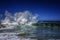 Breathtaking scenery of crazy sea waves making a storm under the clear blue sky