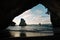 Breathtaking shot of a huge rock in the middle of the sea on Cathedral Cove, New Zealand