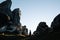 Breathtaking shot of a male staring at the huge rocks in Kura, Tawhiti