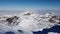 Breathtaking shot of peak of snowy alps covered by clouds