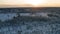 Breathtaking Sunset fly at high attitude backward over Snow Covered Pine Tree Forest Landscape In Northern Sweden and landing