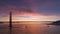 Breathtaking sunset with pink purple clouds on background of Golden Gate Bridge