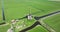 A breathtaking view of an ancient Dutch windmill, standing tall amidst the lush green polder landscape, captured by an