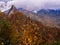 Breathtaking view of Chimney Tops Mountain in fall foliage with dramatic clouds in the Great Smoky Mountains National Park