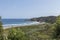 A Breathtaking View from a Cliff: Overlooking a Pristine Beach and the Vast Ocean