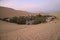 Breathtaking view of Huacachina, the oasis town as seen from the sand dune at sunset, Peru