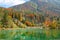 Breathtaking view of lakefront holiday houses hiding in the autumn colored woods