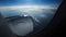 Breathtaking view from plane\'s illuminator during morning flight. 4K video