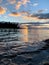 Breathtaking view of the reflection of bright sunset clouds in the rippling lake