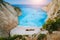 Breathtaking view of Shipwreck middle of sandy Navagio beach surrounded by azure deep turquoise sea saltwater and huge