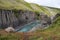 Breathtaking view of Studlagil canyon in Jokuldalur Valley in Iceland. Basalt columns and turquoise glacier river