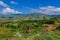 Breathtaking View to the Traditional African Houses, Green Trees and Mountains