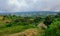 Breathtaking View to the Traditional African Houses, Green Trees and Mountains