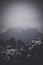 Breathtaking vista of a winter mountain range with a grey sky overhead.