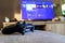 Brecht, Belgium - October 31 2019: A turned on playstation 4 controller lying on a couch in front of a television.