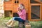 Breeder hens kid girl rancher farmer with chicks in chicken coop