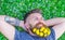 Breeziness concept. Guy with dandelions in beard relaxing, top view. Bearded man with dandelion flowers in beard lay on