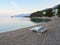 Brela, Croatia - July 24, 2021: Loznica beach with beach chairs in a seaside resort. A quiet morning on the Adriatic.