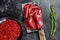 Bresaola dried beef meat sliced on a cleaver. Black background. Top view