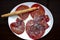 Bresaola, an Italian dish of raw beef cured by salting and air-drying, served typically in slices with a dressing of olive oil, le
