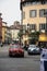 Brescia/Italy - May 17, 2017: Alfa Romeo parked up and another racing through the italian streets for the Mille Miglia race in