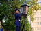 BREST, BELARUS - August 17, 2022: st. Soviet lamplighter lights kerosene lamps of street lamps