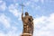 BREST, BELARUS - OCTOBER 19, 2019: The statue of Guardian angel with the cross against blue sky on the Millennium Monument.