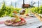 Brettljause, cold plate with meal on wooden table in vineyard