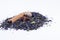 Brew black tea with blue flower petals, nutmeg and cinnamon sticks