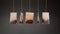 Brewed tea bags on threads hang waved on dark background