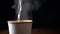 Brewing Hot Tea in a Paper Cup on a Black Background, Close up