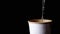 Brewing Hot Tea in a Paper Cup on a Black Background, Close up