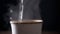 Brewing Hot Tea in a Paper Cup on a Black Background, Close up