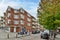 a brick apartment building on the corner of a street