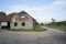 Brick Barn House and Surrounding Gravel Driveway