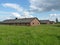 Brick barracks in the meadow in the former concentration camp. Auschwitz, Birkenau