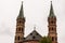 Brick Bell towers of WÃ¼rzburger Cathedral on cloudy sky