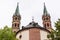 Brick Bell towers of WÃ¼rzburger Cathedral on cloudy sky