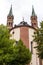 Brick Bell towers of WÃ¼rzburger Cathedral on cloudy sky