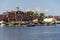 Brick building on the banks of the river and the pier for boats. Summer and rest. Russia, Moscow region, August 2108