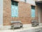 Brick building with blue wooden shuttered windows