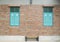 Brick building with blue wooden shuttered windows