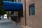 Brick building hotel entrance blue round canopy