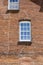 A brick building with a rectangle glass window