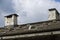 Brick-built chimneys on a roof covered with shingles