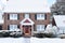 Brick Colonial House with Arched Red Door at the Holidays